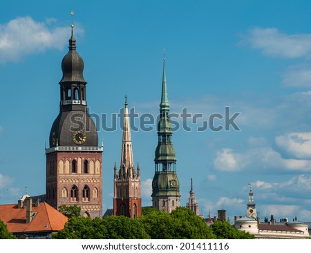 Towers of Riga seen in Riga. Three church towers in the picture are the Riga Dome cathedral,  St. Saviour\'s Church and St. Peter\'s church. On the right is Building of Academy of Sciences
