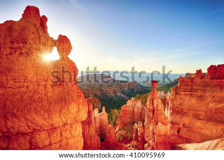 Sun is shining through the rock window in the early morning. Bryce Canyon National Park, Utah, USA.