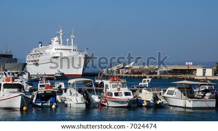 Shipyard with small yachts and a big white cruise ship