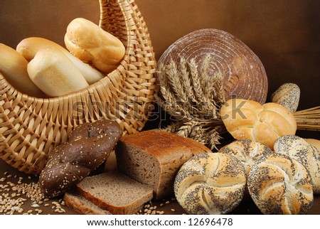 Various fresh baked goods with a basket, wheat grain and a cereal ears