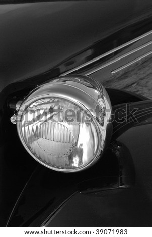 Detail of a vintage (1948) car light in black and white