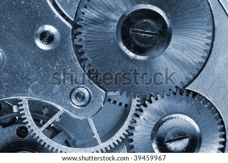 Mechanism of old clock - sprockets in the system are well visible, blue tint
