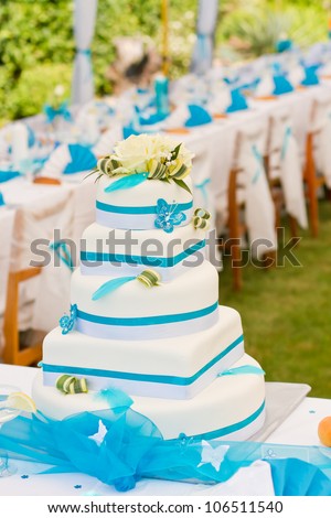 Wedding cake and luxury table setting in white and blue colors
