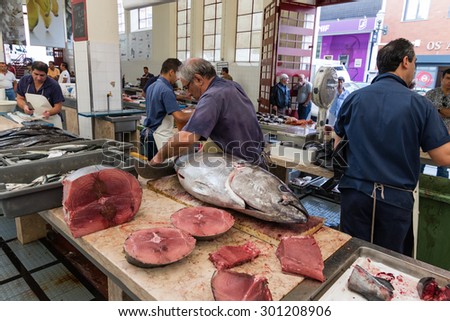 Funchal, Madeira island, Portugal - July 7, 2015: Fish sellers at Mercado dos Lavradores, the famous fish and seafood market of Funchal, the capital of Madeira island
