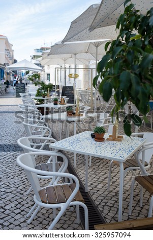 Outdoor restaurant open air cafe chairs with tables in Portugal