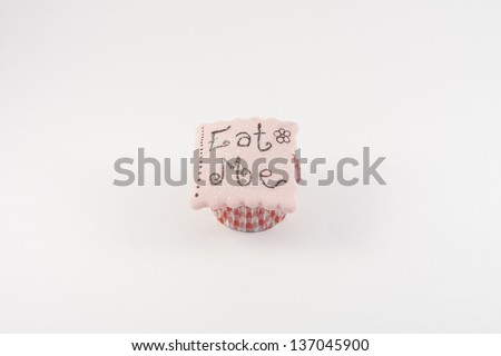 A Cupcake decorated with alice in wonderland