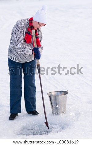 Woman hitting the ice with a ice pick.