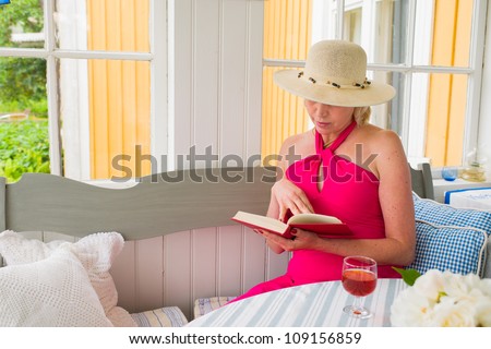 Lady reads a book on the veranda, reposeful atmosphere, horizon format