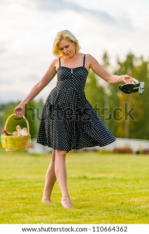 Woman goes to the picnic, barefoot, she takes little dance steps