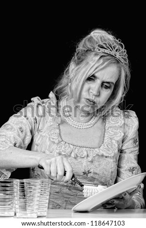 Adult woman and dishes, she has dressed up a princess costume, vertical format