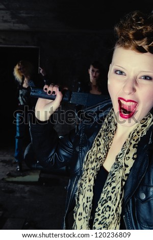Self-confident gang member yelling and has equipped with a machete, vertical format