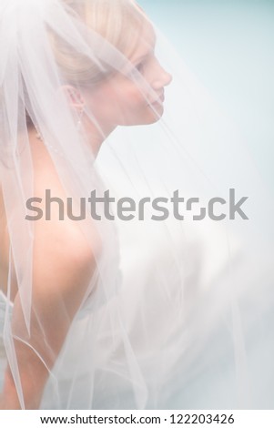 Close up beautiful lonely bride, light blue background, vertical format bride, light blue background, vertical format