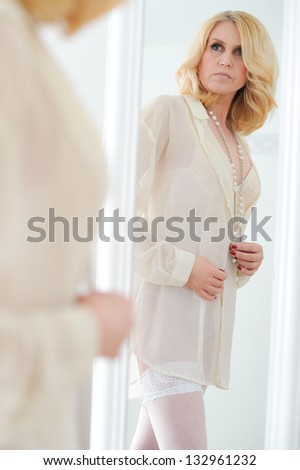 Attractive mature woman use dressing mirror