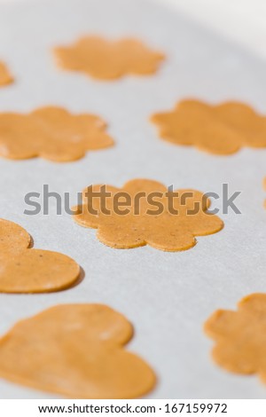 Gingerbread are ready to oven, white parchment below, vertical format