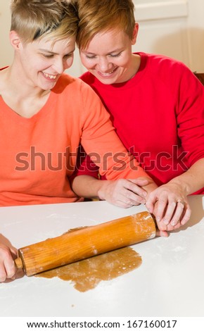 Lovely lesbian couple makes gingerbread in the kitchen