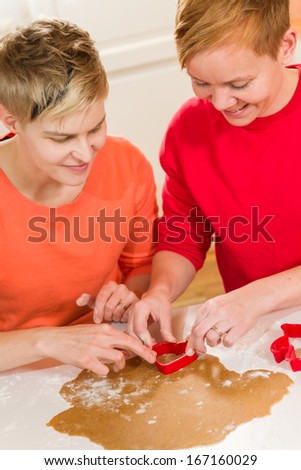 Lovely lesbian couple makes gingerbread in the kitchen
