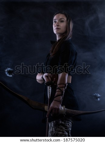 Beautiful archery woman and smoky background