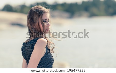 Longing woman, beautiful young woman looks into the distance
