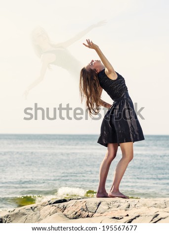 Beautiful young woman dancing outdoors and soul flying out