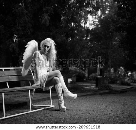 Sexy woman wearing white angel costume and wings