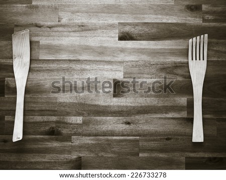 Wooden fork and spatula on the table - tinted black and white image
