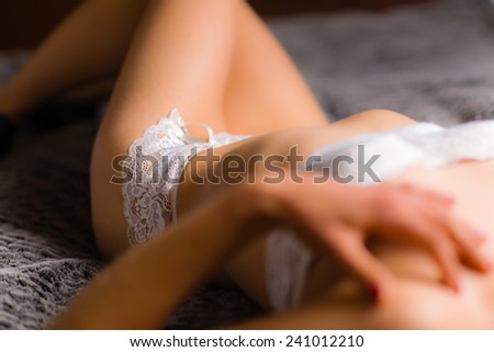 Boudoir, attractive young woman wearing lingerie and she lying on the bed