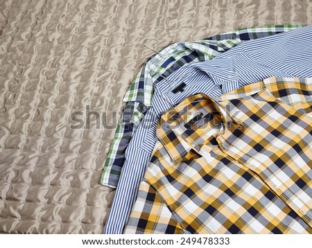 Men\'s casual patterned shirts on the bed