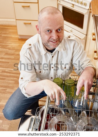 Homeworks, smiling man to fill the dishwasher