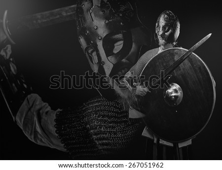 Medieval knight armor with a sword, helmet and shield, black and white image