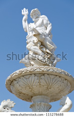 Beautifull carved water fountain topped by the god of water, Poseidon or Neptune