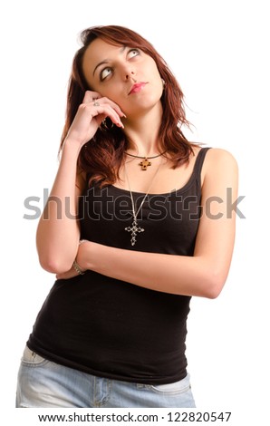Pensive attractive young woman in casual clothes wearing a cross around her neck staring up into the sky lost in thought isolated on white