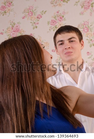 Close-up shot of a young couple. She turns around to face him