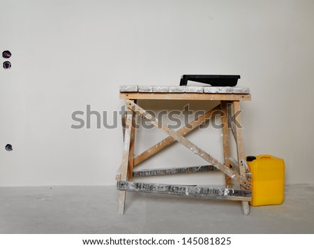 Painting equipment standing ready on a wooden trestle for renovating and redecorating the house