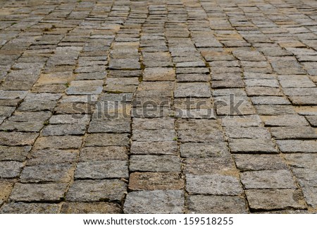 Low angle view of a cobblestone background with stone paving as found in an exterior pedestrian walkway, street or parking area