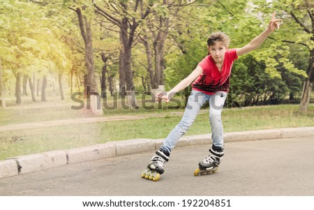Attractive teenage girl roller skating on roller blades on a tarred rural road rounding a bend at speed with her arms flying