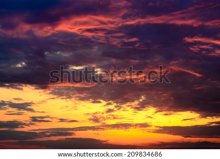 Celestial background of a dramatic beautiful fiery orange and purple sunset lighting up the cloudsCelestial background of a dramatic beautiful fiery orange and purple sunset lighting up the clouds