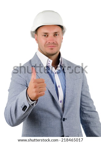 Man wearing a hardhat cheering in jubilation and punching the air with his fist as he celebrates a success, conceptual of a builder, architect or engineer