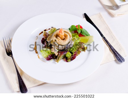 Gourmet Mouthwatering Specialty Main Entree Recipe of Fish and Shrimp Meat Prepared on White Round Plate with Veggies at the Restaurant