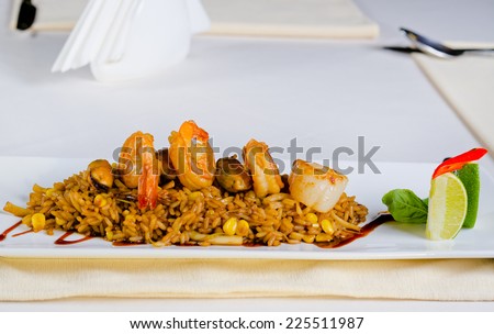 Mouth Watering Main Dish Lemony Risotto with Shrimps on Top. Prepared on White Rectangular Plate, Dine in White Table