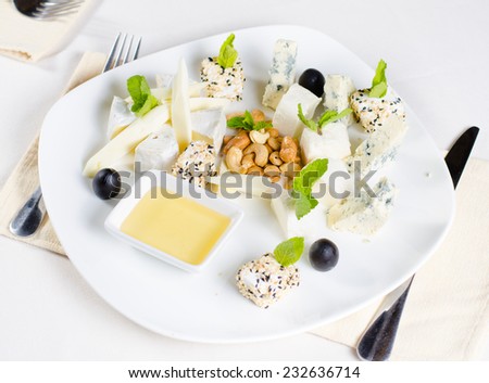 Overhead of Gourmet Cheese Platter Appetizer with Variety of Cheeses, Nuts, and Olives
