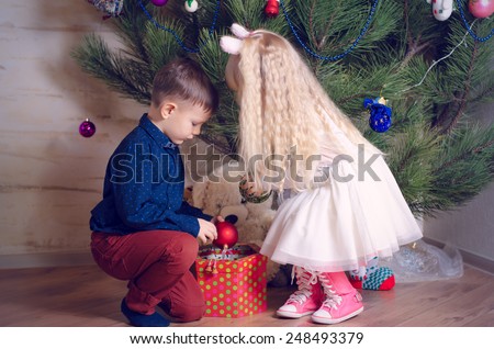 Close up Helpful Kids in Trendy Outfits Decorating a Huge Home Christmas Tree with Balls from a Box