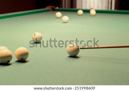 Close up Scattered White Pool Balls and Taco on Top of Green Table