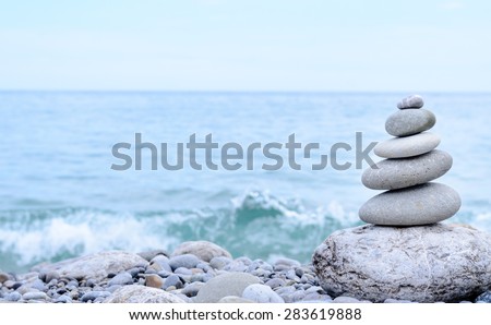 Conceptual Stack of Six Dry Stones at the Sea, from Biggest to Smallest Size