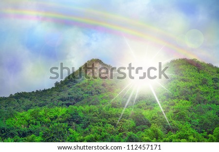 Beautiful sky cloud rainbow , green mountains dramatic light