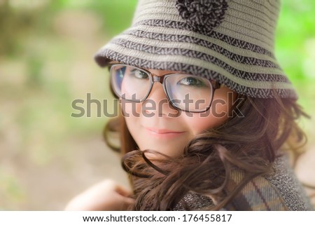 Pretty fat Asian woman eyeglasses nice curl-hair look to camera background green blur