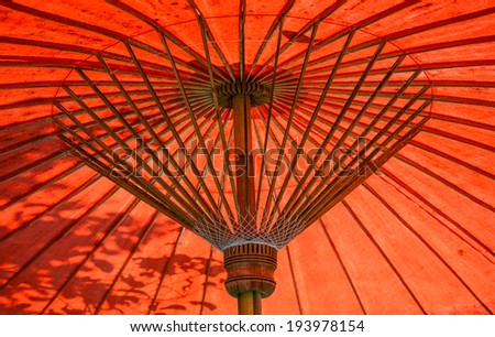 abstack-Close up red old-fashioned umbrella,sunlight effect shadow leaf to left umbrella, abstack art photography