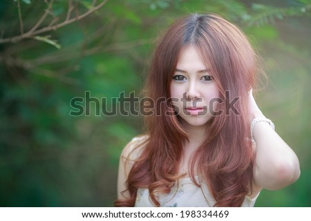 shy sexsy in love spring smile on garden sunlight ,sexsy portrait of young woman relax in the park ,Beautiful young with white hat on green leaf background