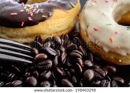 Coffee beans donuts milk donut Silver fork macro,Delicious chocolate milk donut close up cofee beans,Aromatherapy looking wake up when sleepy