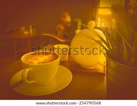 Cup OfCoffee with kettle cafe Interior on table yellow retro,  Behind have dog looking camera