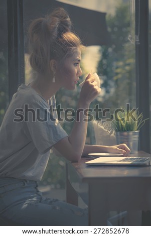 Dark style beauty some only position of the light down adult woman sipping coffee looking through window and thinking for plan something vintage morning she as always thinking sitting at cafe coffee